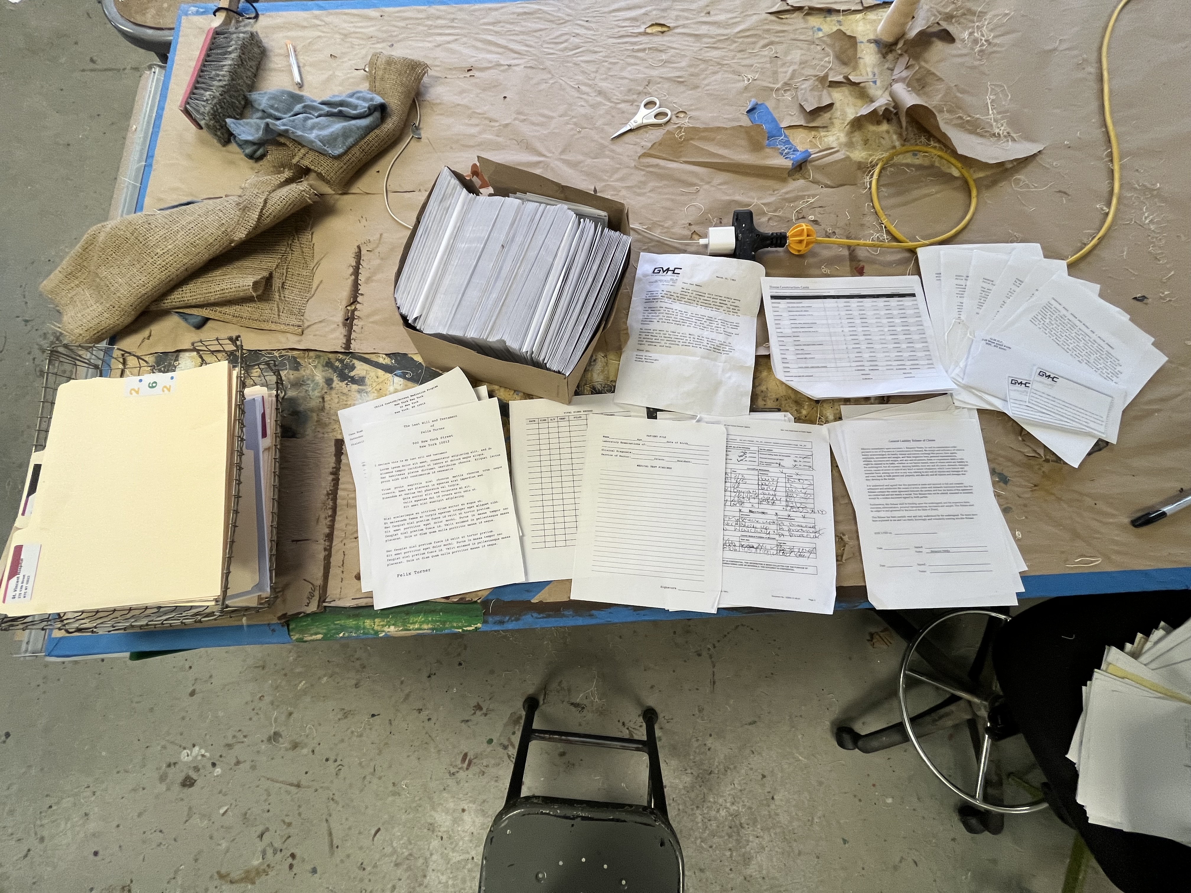 Multiple sheets of printed papers scattered on a table.