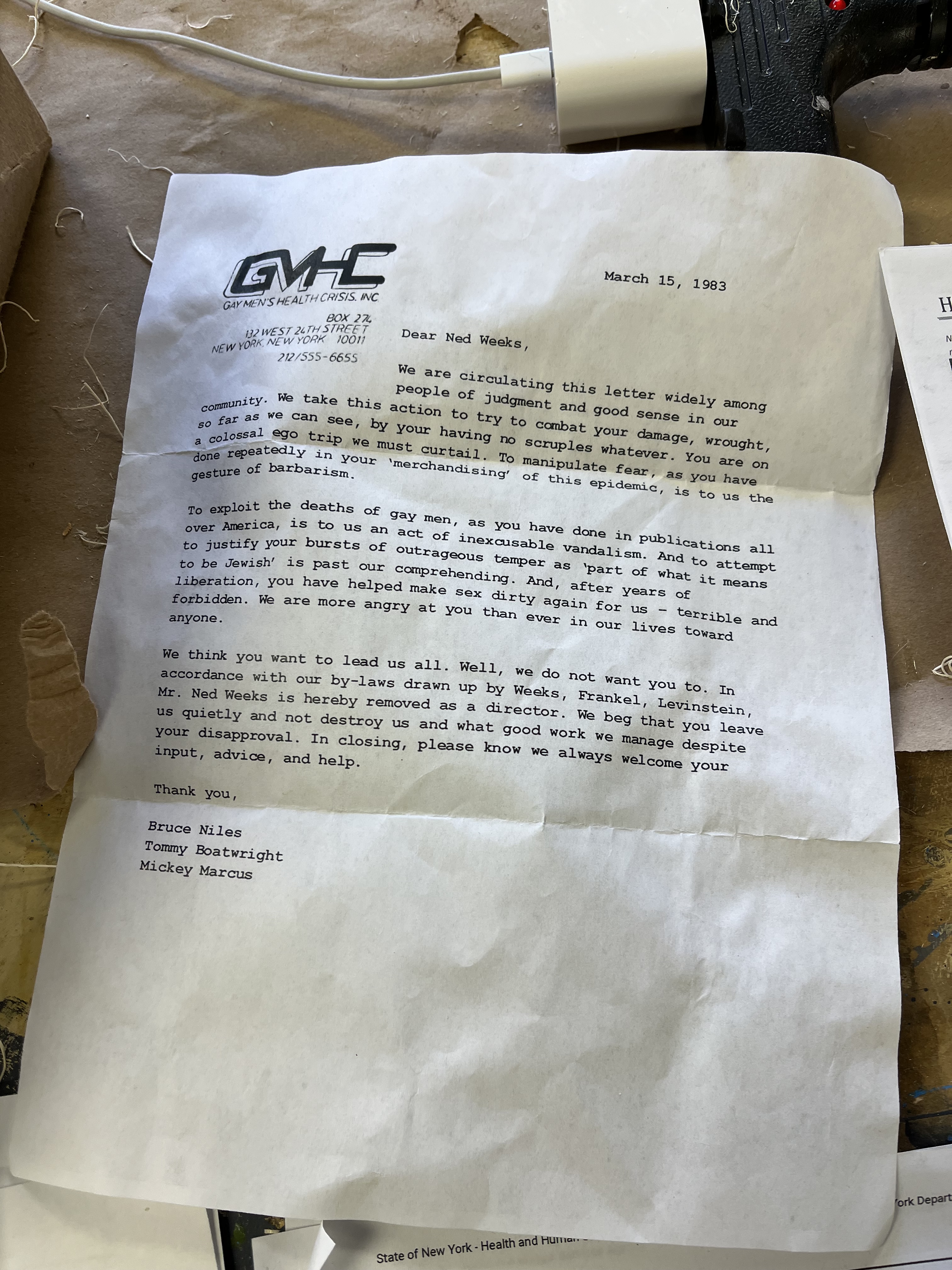 A printed paper with the Gay Men's health crisis and logo